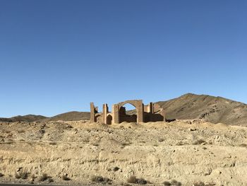 Old ruins in desert against clear blue sky