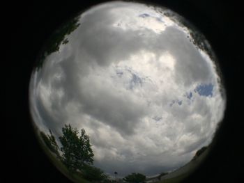 Low angle view of moon against cloudy sky