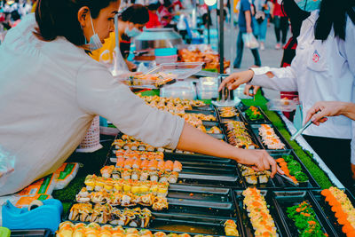 Group of people at market stall