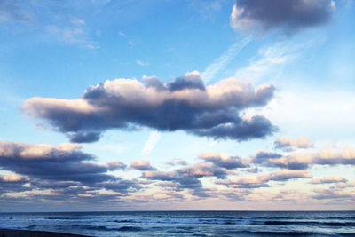 Scenic view of sea against cloudy sky