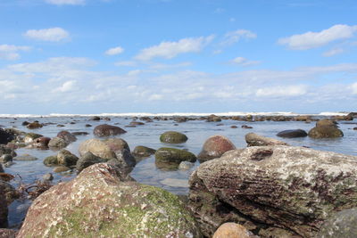 Rocks in sea against sky