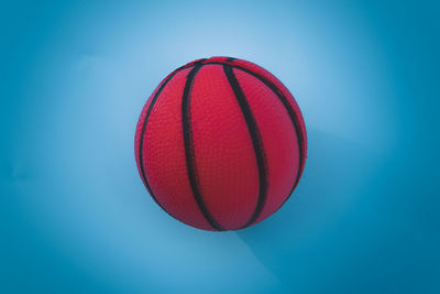 Low angle view of basketball hoop against blue background