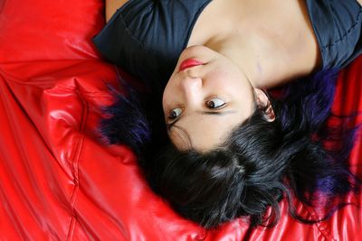 Close-up of woman sitting on wall