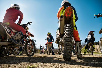 People riding motorcycle against sky