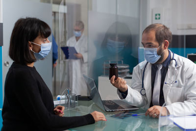 Female doctor examining patient in office