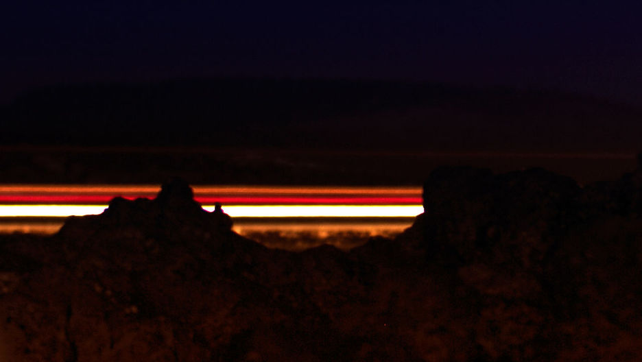 SILHOUETTE OF ILLUMINATED LIGHT AT SUNSET