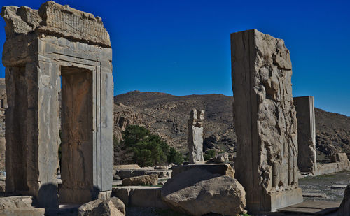 Old ruin building against blue sky persepolis