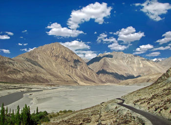 Scenic view of landscape and mountains against sky