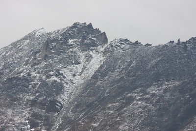 Low angle view of snowcapped mountain against sky