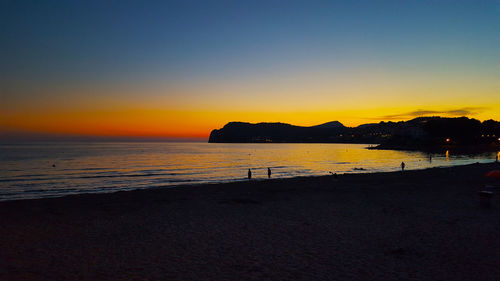 Scenic view of sea against clear sky during sunset