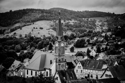 High angle view of church and houses against mountains