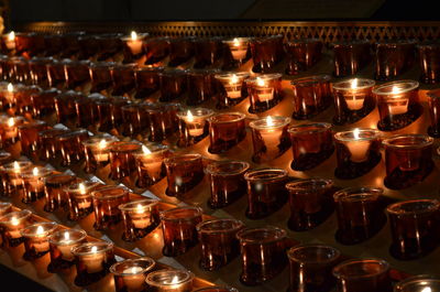 Glasses of tea light candles in temple