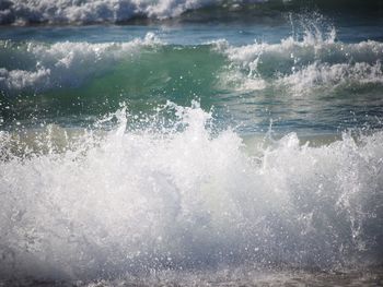 Close-up of waves in sea against sky