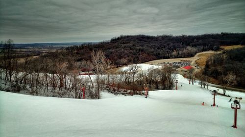 Snow covered landscape against sky