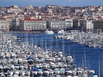 High angle view of boats moored at harbor in city