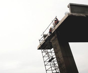 Low angle view of construction site against clear sky