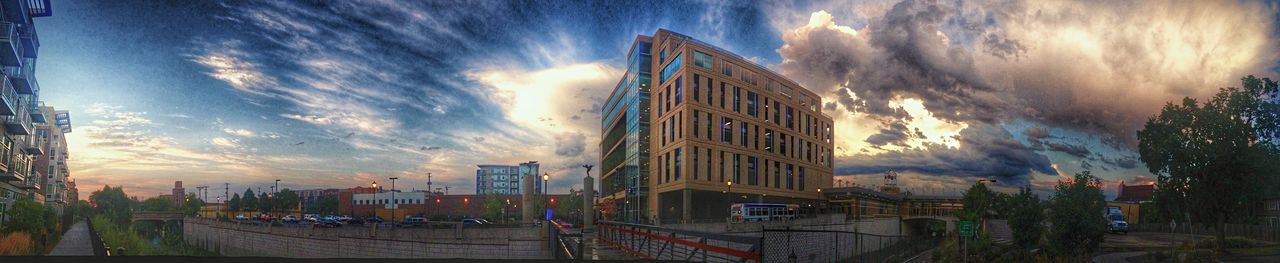 Buildings against cloudy sky