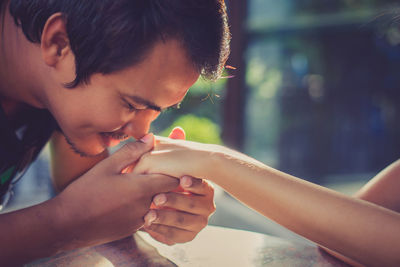 Close-up of boy holding hands