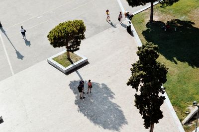 High angle view of people walking on sidewalk in city