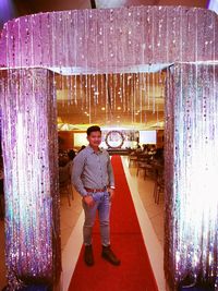 Full length rear view portrait of man standing at night