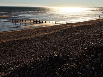 Scenic view of beach against sky during sunset