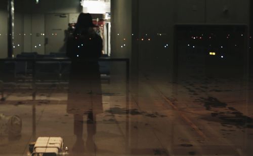 Woman standing in illuminated room