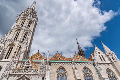 Low angle view of church against cloudy sky