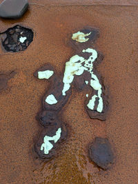 High angle view of broken glass on sand