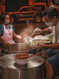 Rear view of people having food