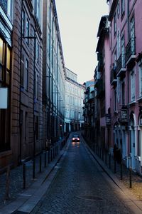 Empty alley amidst buildings in city