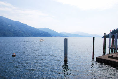 Scenic view of sea and mountains against sky