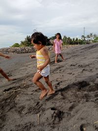 Full length of mother and girl lying on land