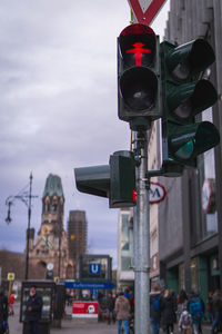 Vehicles on road against sky in city