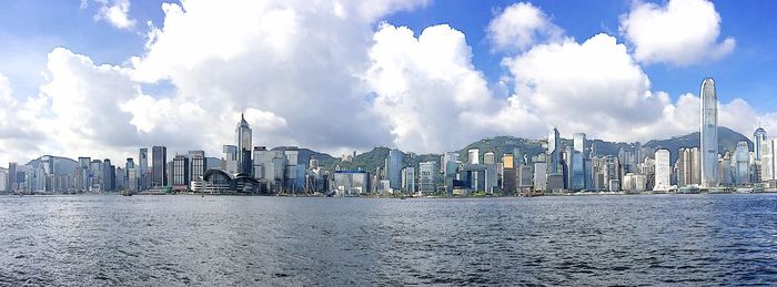 Cityscape against cloudy sky