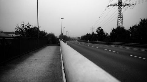 Road amidst trees against sky