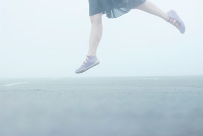 Low section of woman walking on tiled floor