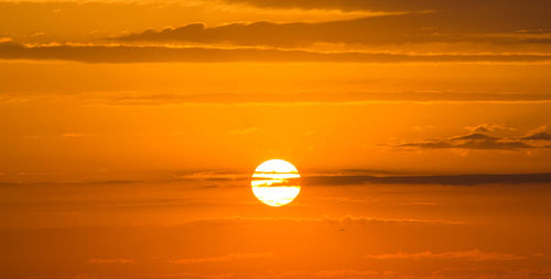 Scenic view of sea against orange sky