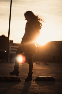 Side view of woman at sunset