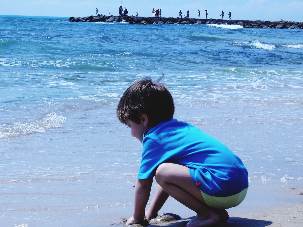 REAR VIEW OF BOY ON BEACH