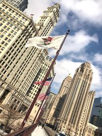 Low angle view of buildings against cloudy sky