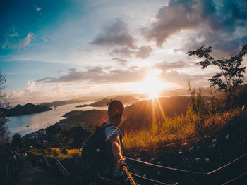 Rear view of woman looking at sunset