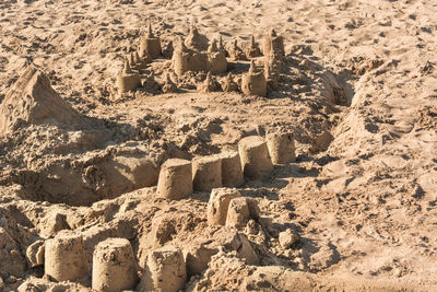 Full frame shot of sandcastles at beach