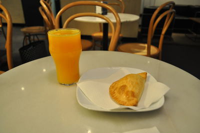 High angle view of empanada with drink served on table in restaurant