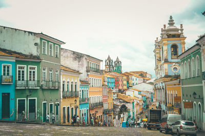 People on street amidst buildings in town