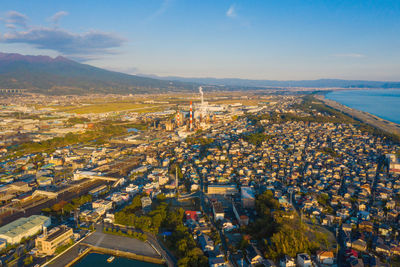 High angle view of buildings by sea against sky