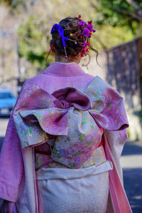 Rear view of woman with pink umbrella