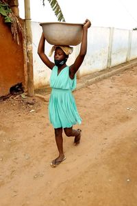 Full length portrait of a smiling young woman