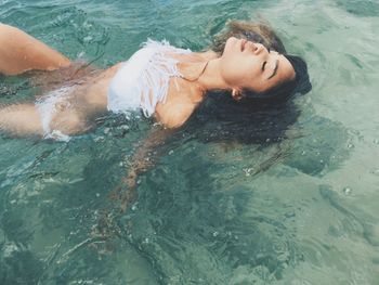 High angle view of young woman swimming in water