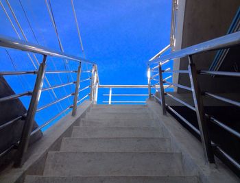 Low angle view of stairs against blue sky