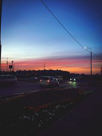 Traffic on road at sunset